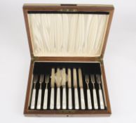 A set of six George VI silver and mother of pearl dessert knives and forks,hallmarked Sheffield