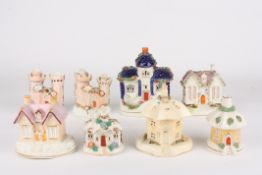 A collection of eight Victorian Staffordshire pottery pastille burner cottagesall with encrusted
