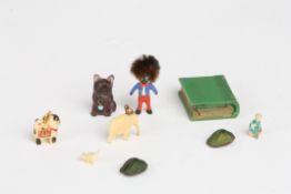A small collection of miniature charms and other itemsincluding a glass dog, two carved bone