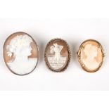 Three carved cameo brooches
carved with portraits of women, one in a white metal mount, two in