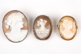 Three carved cameo broochescarved with portraits of women, one in a white metal mount, two in