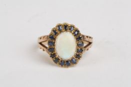 An opal and sapphire cluster ringof oval form in a split shank setting, Size O 1/2.Condition: