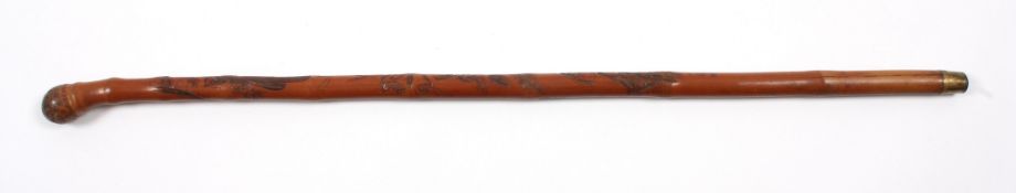 A late 19th century Japanese bamboo walking stickcarved with a scene of a boy at the foot of a