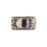 An Edwardian Art Nouveau silver and bluejohn brooch
the oval stone set in a silver frame decorated
