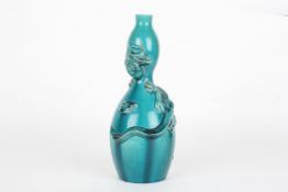 A late 19th century Chinese turquoise glaze double gourd vasedecorated with a dragon in relief,