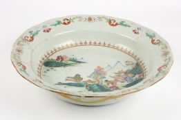 A large mid 19th century Chinese porcelain deep dishpainted with a landscape scene with buildings