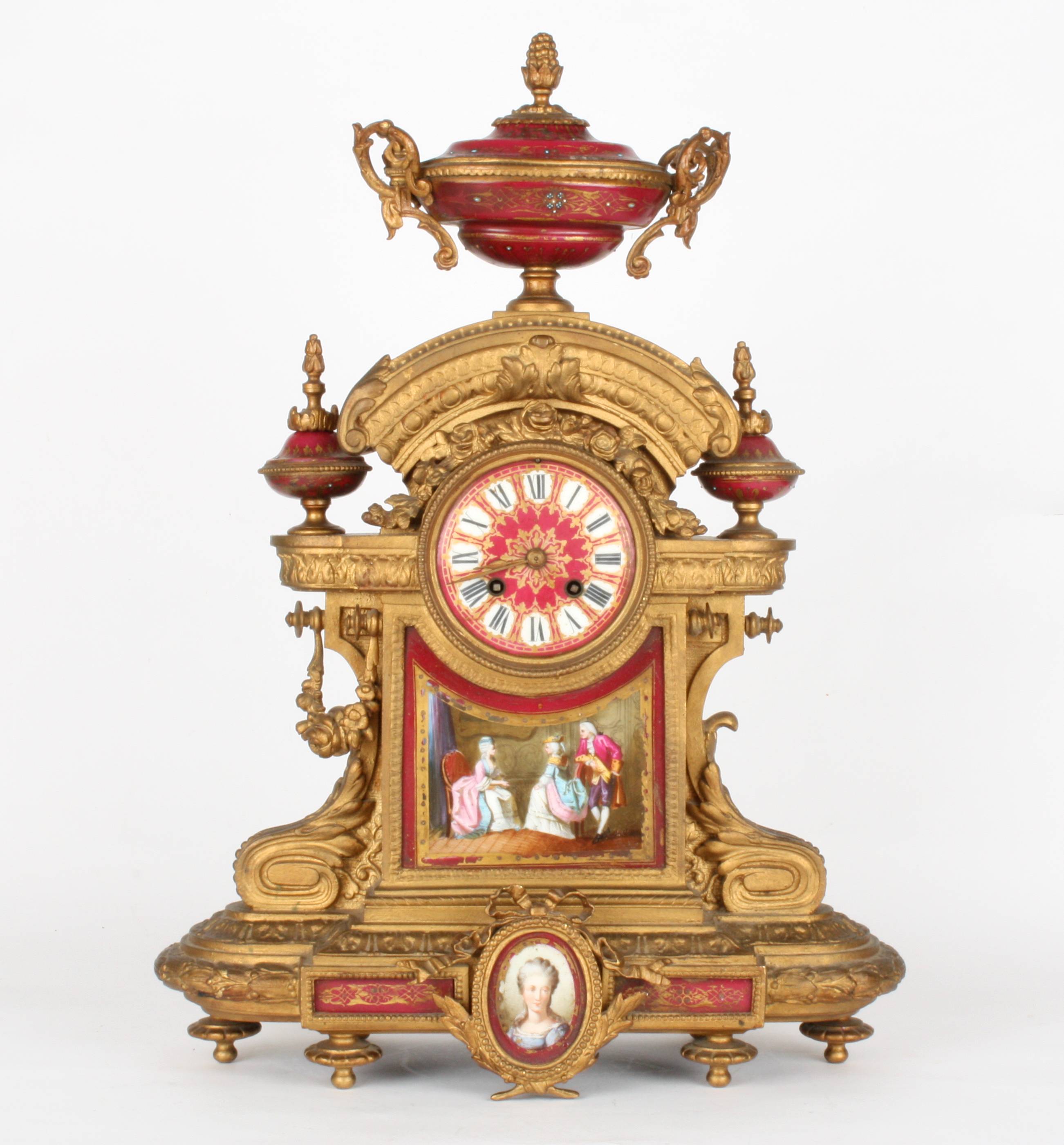 A large late 19th century French gilt painted metal and porcelain clock garniture
the clock with