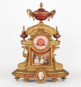 A large late 19th century French gilt painted metal and porcelain clock garniturethe clock with