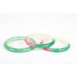 Three modern jade bangles
two with pink, another green, 8cmCondition: All in fair condition