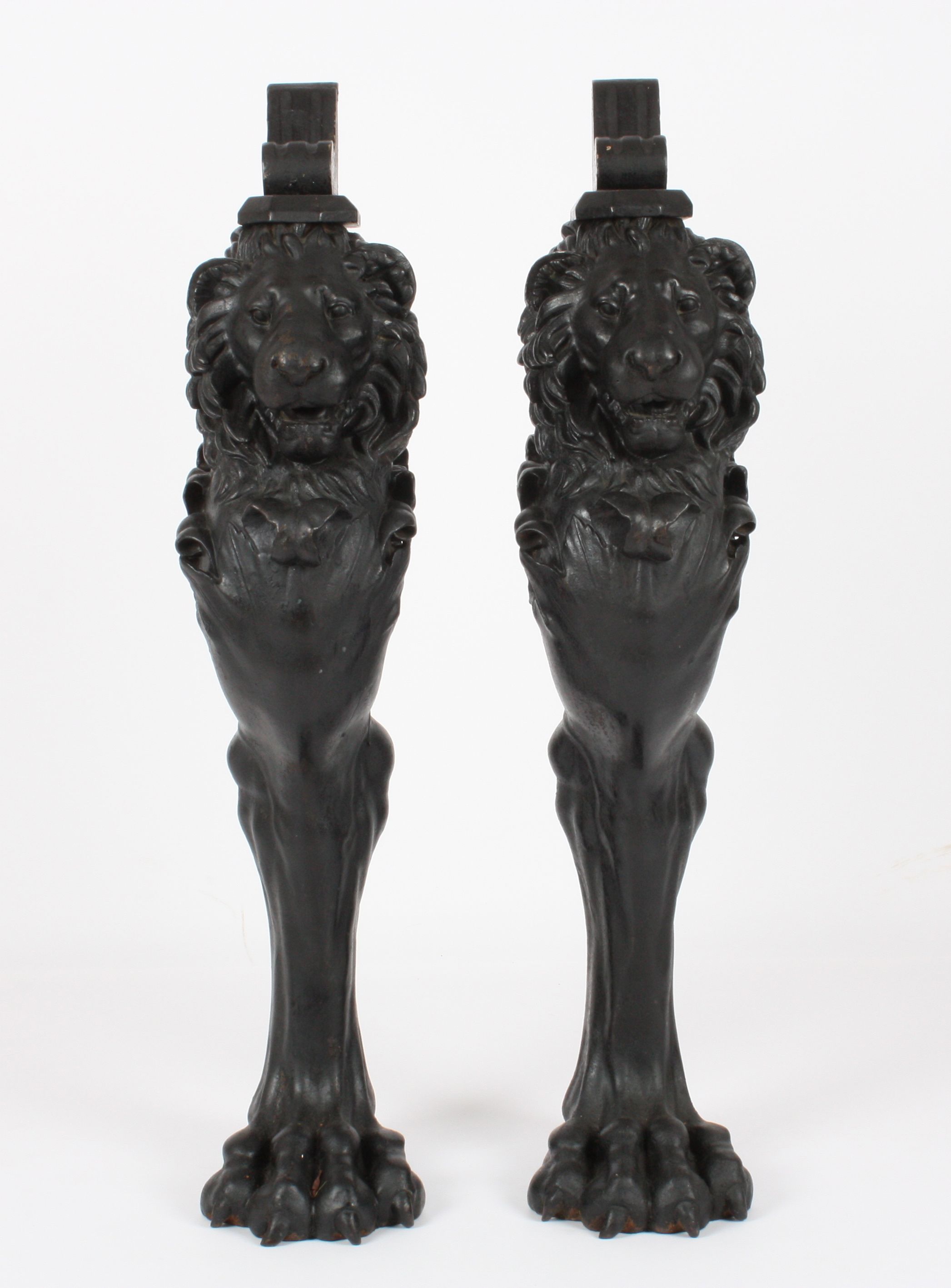 A pair of Victorian design heavy cast iron lion caryatid console supports
the lions in black painted