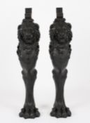 A pair of Victorian design heavy cast iron lion caryatid console supportsthe lions in black painted