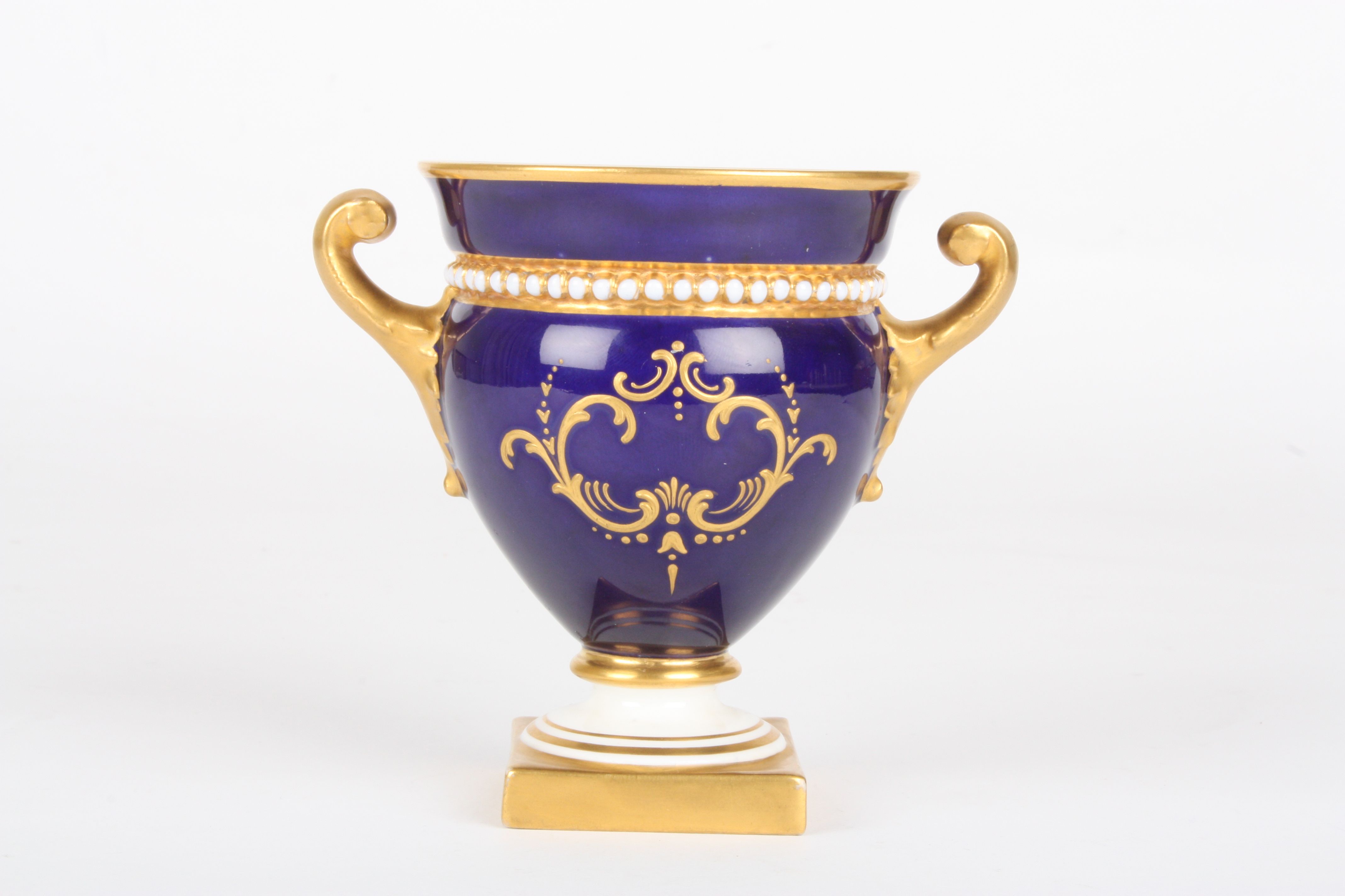 A small Royal Worcester painted campagna vase
signed by William Hawkins, painted with a panel of - Image 2 of 3