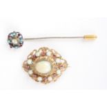 A Hungarian silver gilt brooch
with pierced decorated and mounted with central opal surrounded by