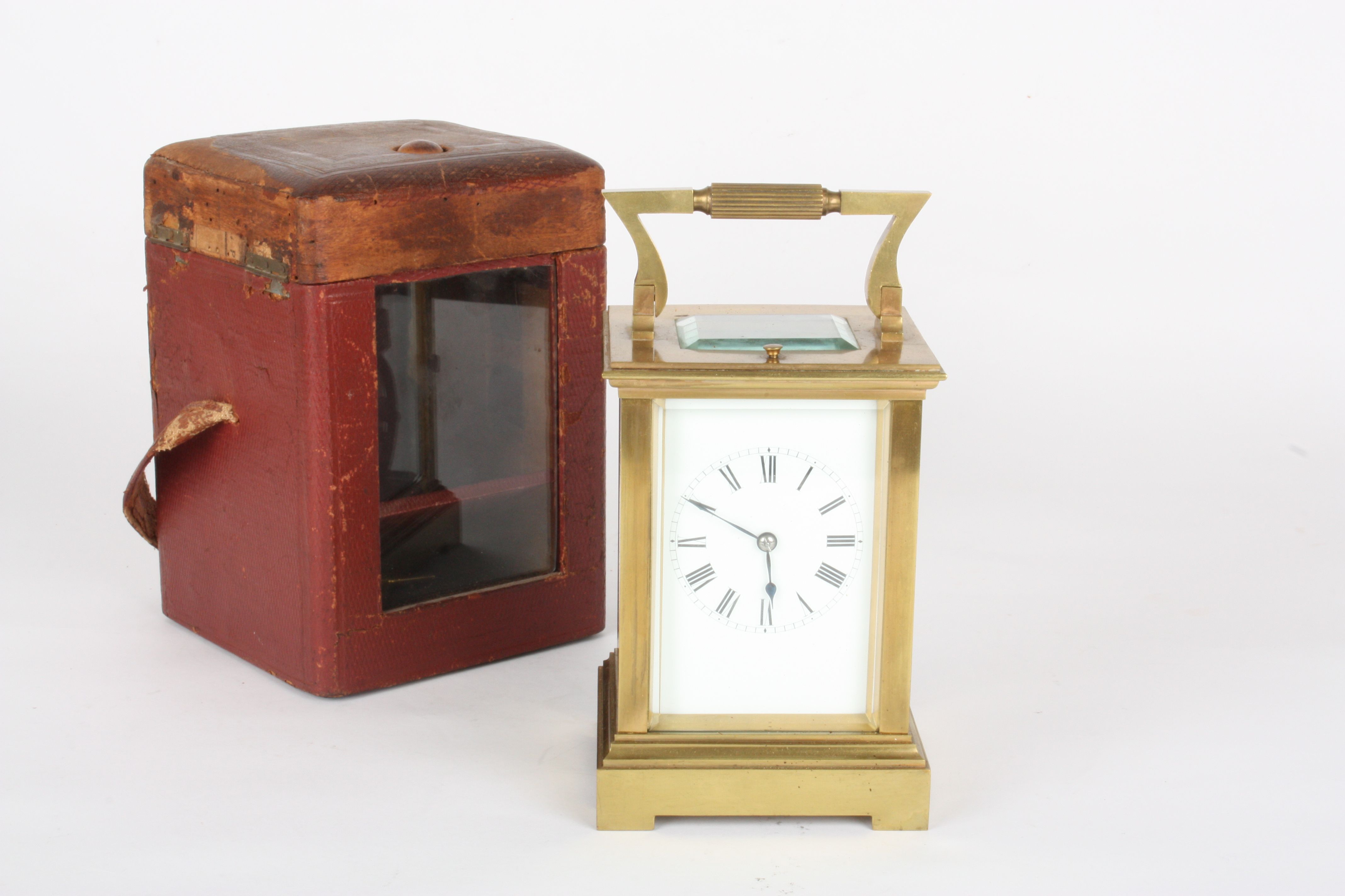 An Edwardian brass repeating carriage clock
with white enamel dial and black Roman numerals, plain