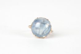 A large cabochon pale blue sapphire ring set with stone measuring 16x15x8mm, in a plain unmarked
