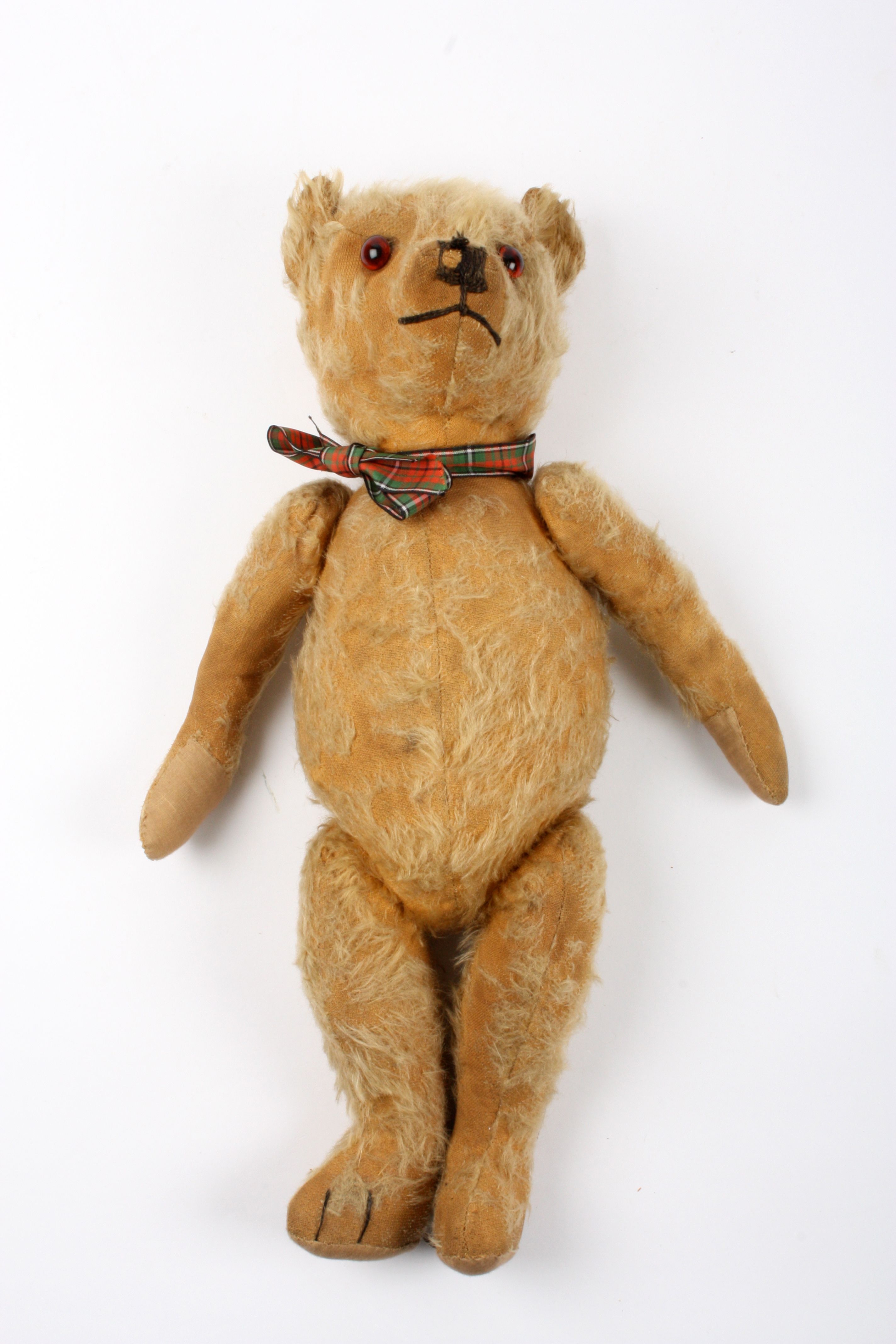 A 1920s Chiltern mohair teddy bear
with articulated mohair head, legs and arms, 45 cm long.