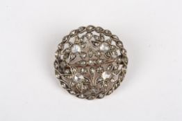 An early 20th century diamond roundel broochset with four diamonds weighing approx 0.15cts each,