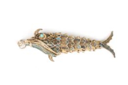 A filigree silver gilt and enamel locket in the form of a fishwith articulated body, and hinged
