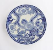 A large 20th century Japanese blue and white circular charger, decorated with dog of foe, surrounded