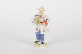 A mid 20th century Meissen porcelain figure of an oriental womanstood holding a bunch of grapes,