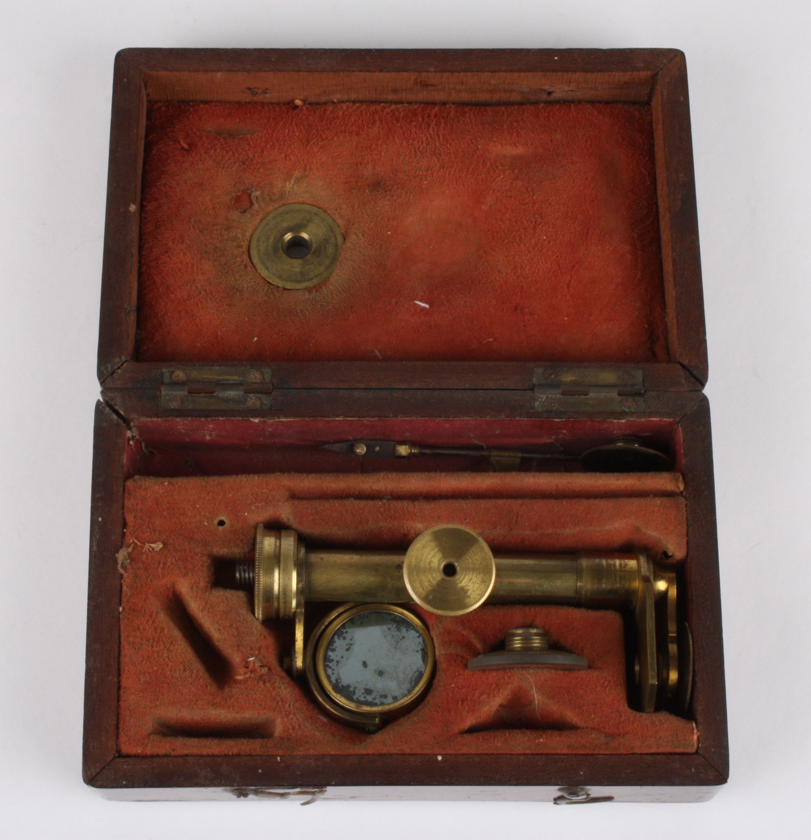 A 19th century simple brass microscope
contained within a fitted mahogany case together with a