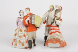 A pair of mid 20th century Russian porcelain figures of dancerseach formed as a dancing couple, one