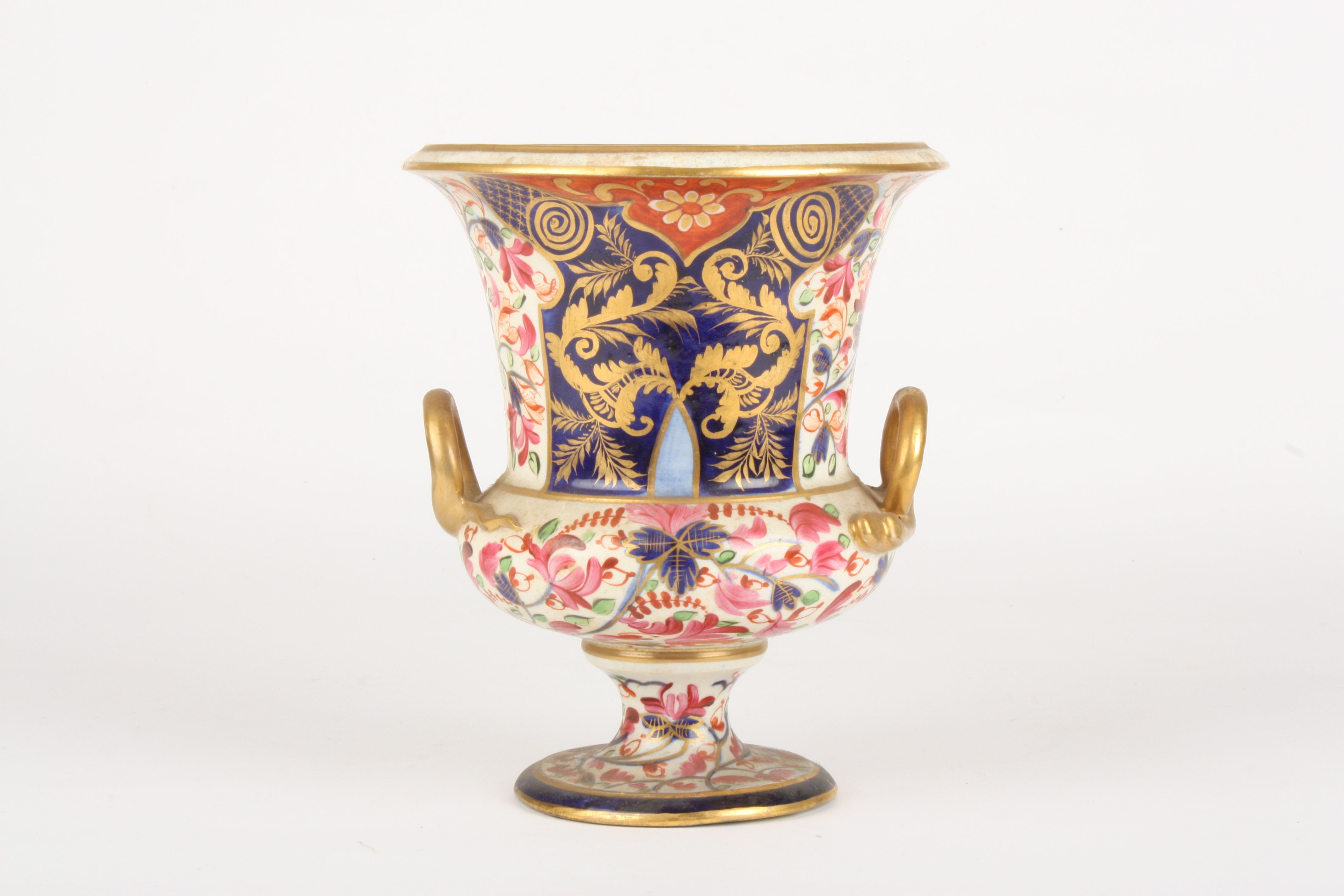 An early 19th century Derby Imari campagna urn
decorated with pink flowers, leaves and scrolls on