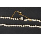 A natural pearl necklace with diamond clasp
of 107 pearls each measuring approximately 3.5mm in