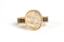 A gentleman's George III mourning ringwith central oval panel of plaited hair, the shank