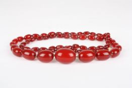 A late 19th century cherry amber necklacethe graduated beads with screw fastener, overall length