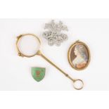 A small group of objets d'art
comprising an oval portrait miniature, a paste clip brooch, an