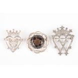 A group of three Scottish silver brooches
including an Iona pierced and engraved silver brooch and