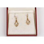 A pair of 9ct gold and diamond drop earrings
set in pear shaped mounts, Condition: Good condition