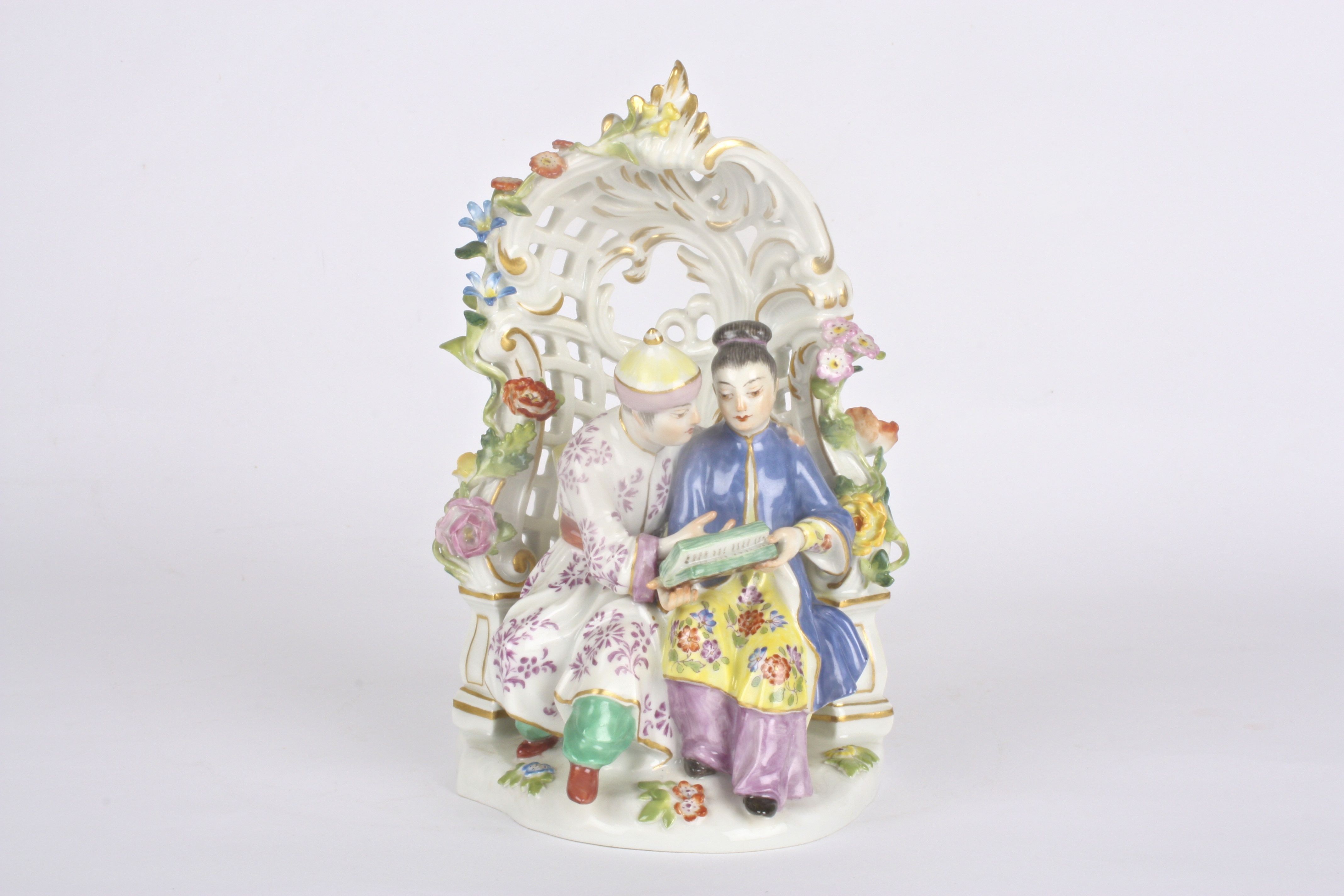 Late 20th Meissen figure group, after Kaendler, Chinese man and woman under a bower, seated in