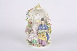 Late 20th Meissen figure group, after Kaendler, Chinese man and woman under a bower, seated in