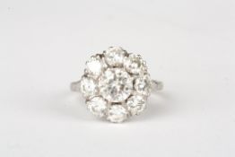 A large 18ct gold diamond daisy cluster ringthe central stone weighing approx 1.08cts, surrounded