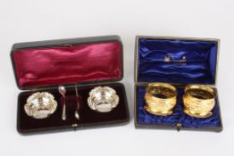A pair of silver gilt embossed napkin rings, hallmarked Chester 1893, makers mark James Deakin &