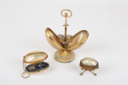 A 19th century mother-of-pearl and gilt metal etuithe ovoid shell case opening in two halves to