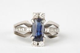 A sapphire and diamond ringthe central baguette cut sapphire flanked top and bottom by two small