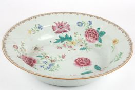 A large early 19th century Chinese porcelain Famille Rose deep dishpainted with vignettes of bright