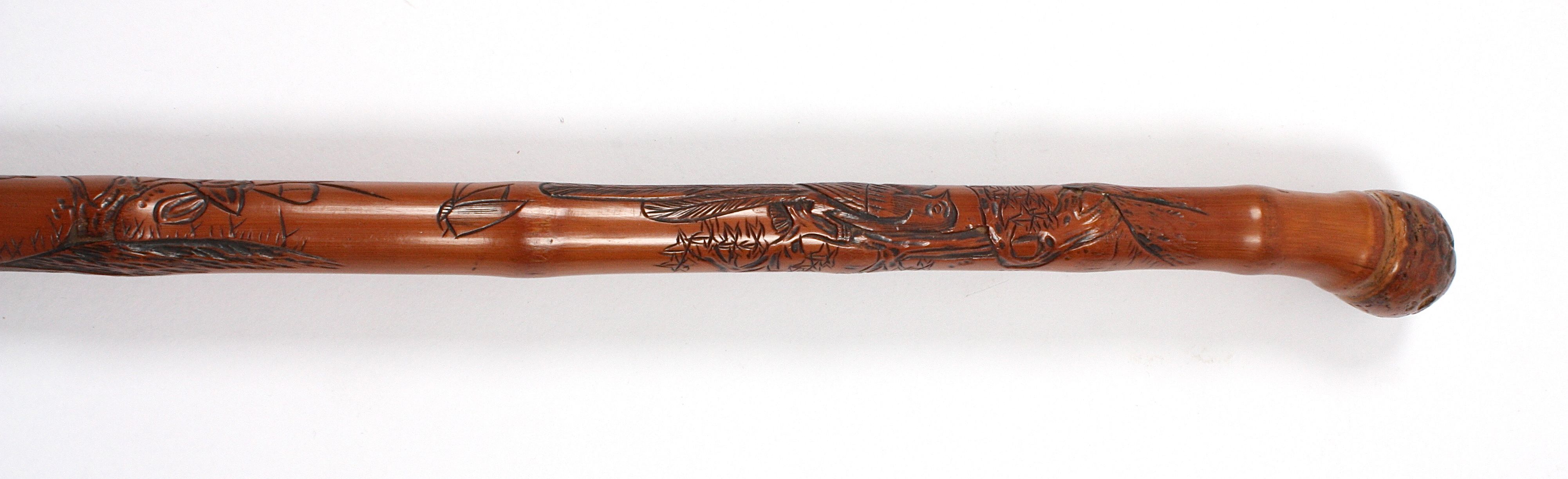 A late 19th century Japanese bamboo walking stick
carved with a scene of a boy at the foot of a - Image 3 of 3