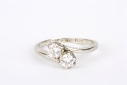 A two stone 18ct gold and platinum ringset with two diamonds in claw setting, each diamond
