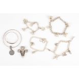 A collection of assorted silver jewellery
including four charm bracelets, a christening bracelet,