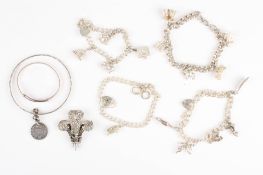 A collection of assorted silver jewelleryincluding four charm bracelets, a christening bracelet,