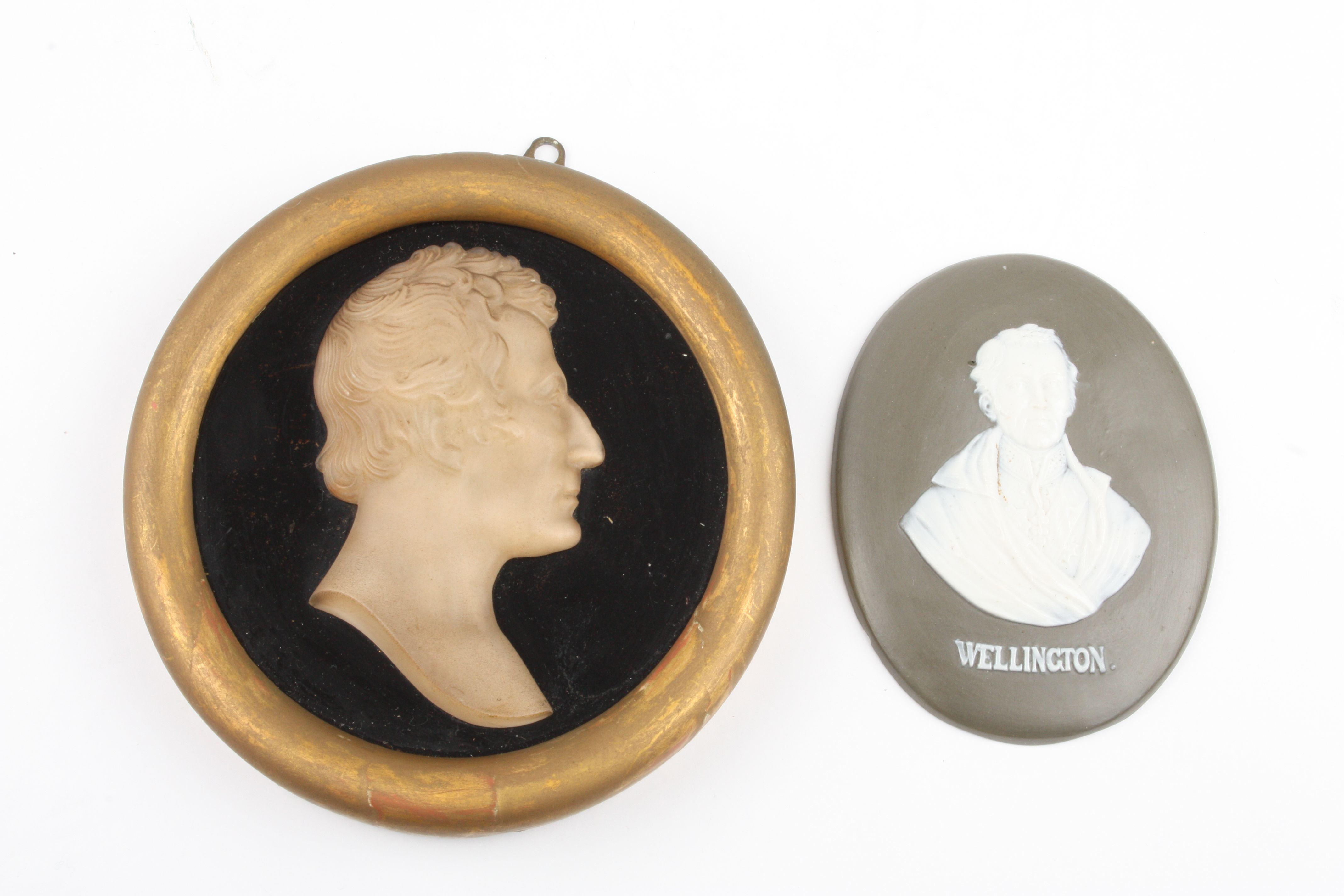 A Victorian frosted glass cameo type plaque of Wellington
together with a Continental bisque