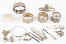 A small collection of assorted silver itemsincluding five napkin rings, a stiff bangle, a fruit