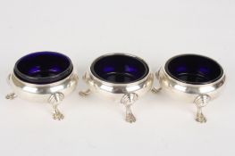 A set of three George II silver saltshallmarked London c.1736, of plain form and supported on three