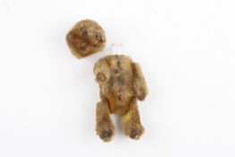 A small early 20th century Schuco teddy bear scent perfume bottlewith removable head and mohair
