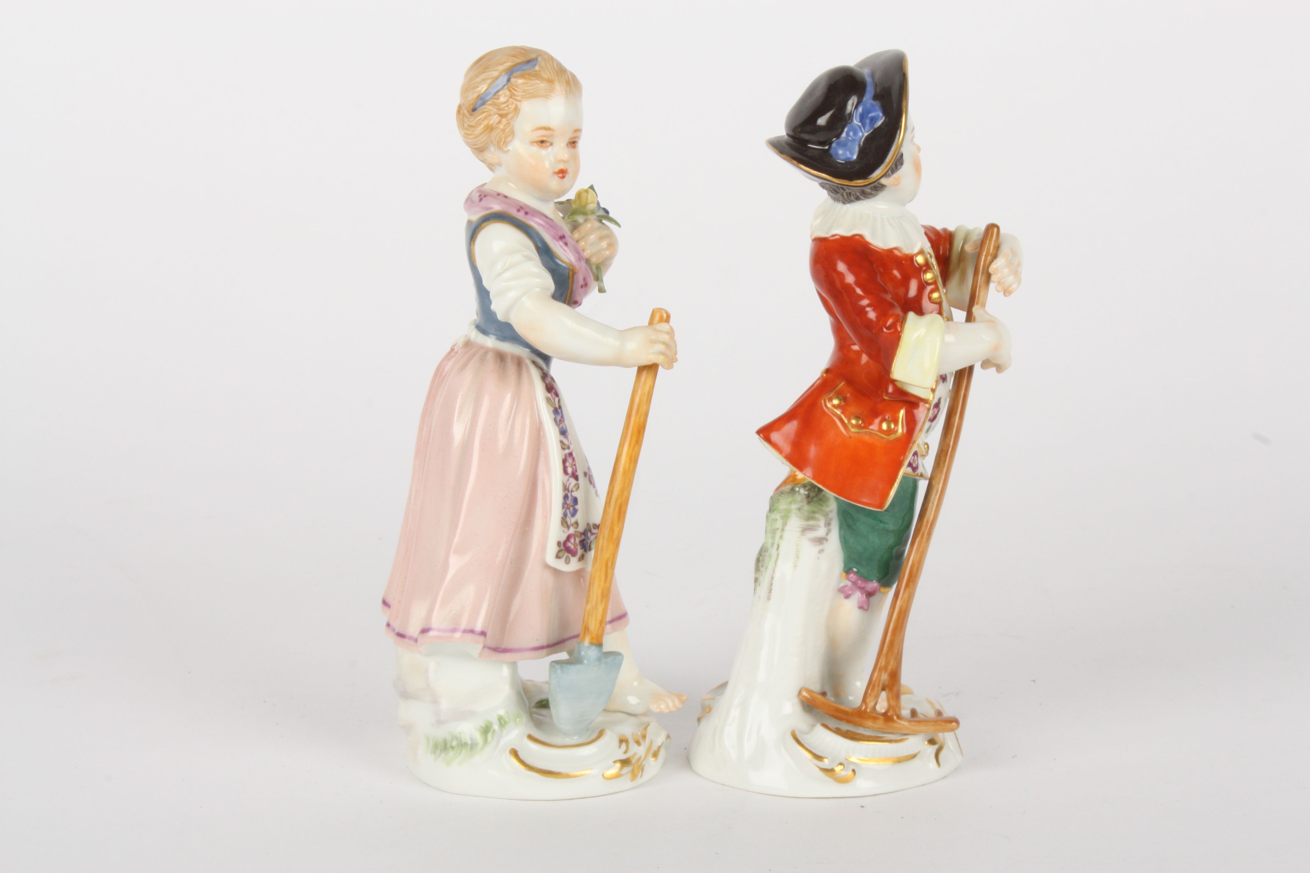 Pair of Late 20th century Meissen figures modelled as a gardening boy holding a rake and girl - Image 4 of 5