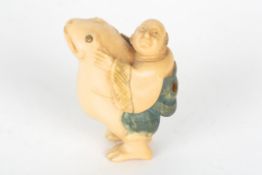 An early 20th century Japanese carved ivory netsukeformed as a figure of a man riding on the back